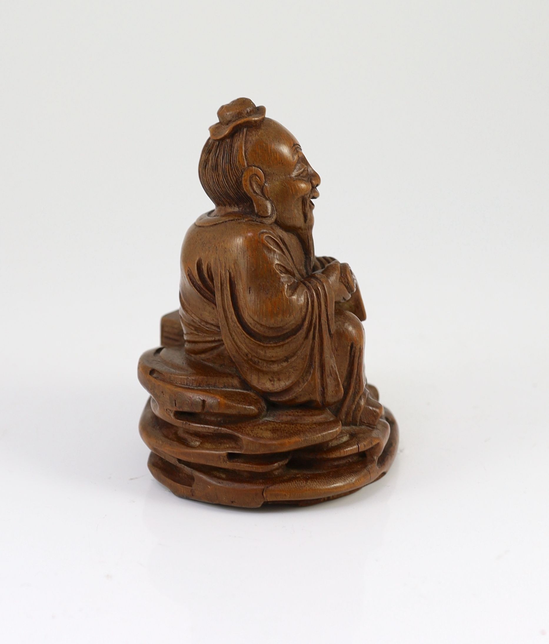 A Chinese carved bamboo figure of a seated sage reading a book, a boy beside him, probably 19th century, 15cm high